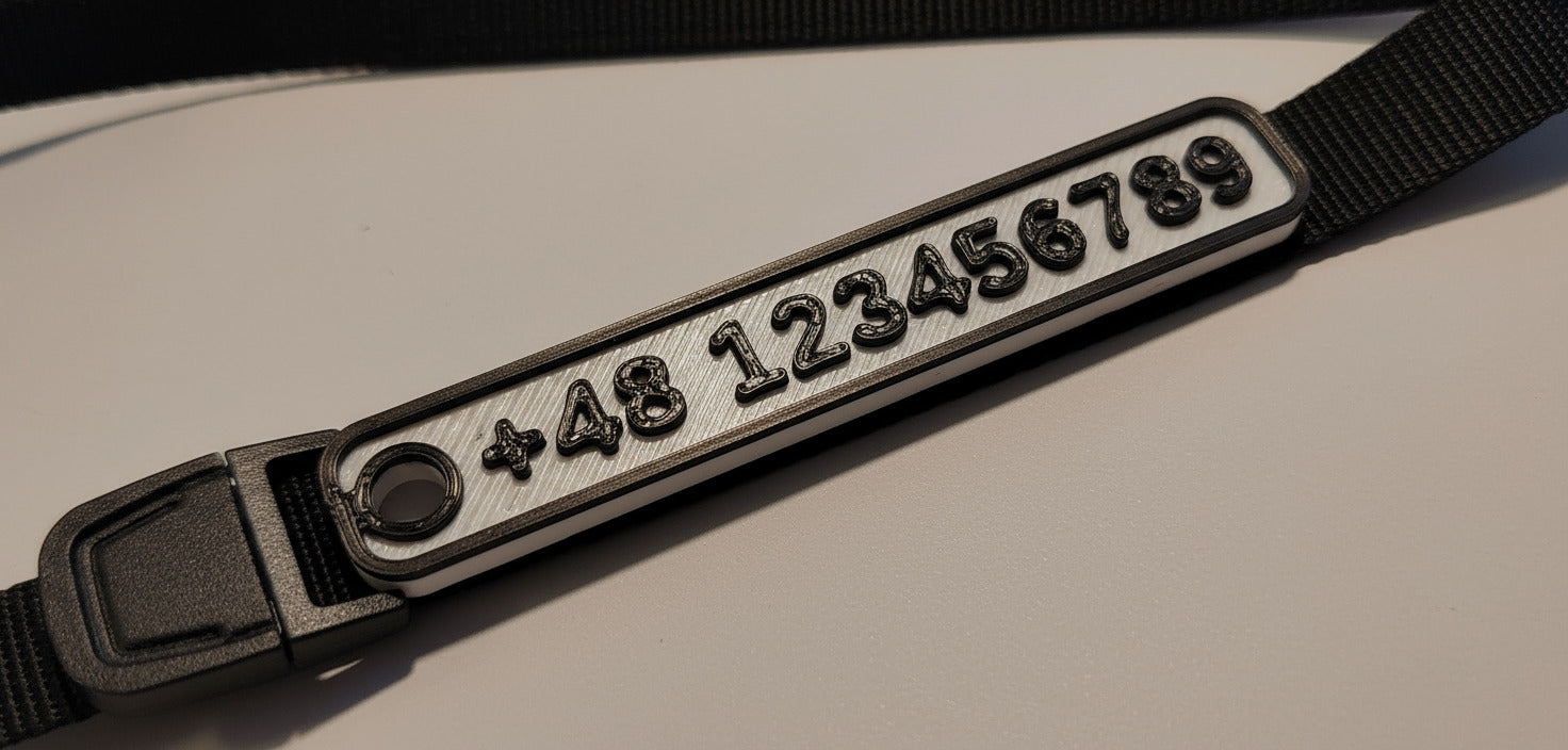 Black strap with metallic label displaying numbers and symbols on a light background